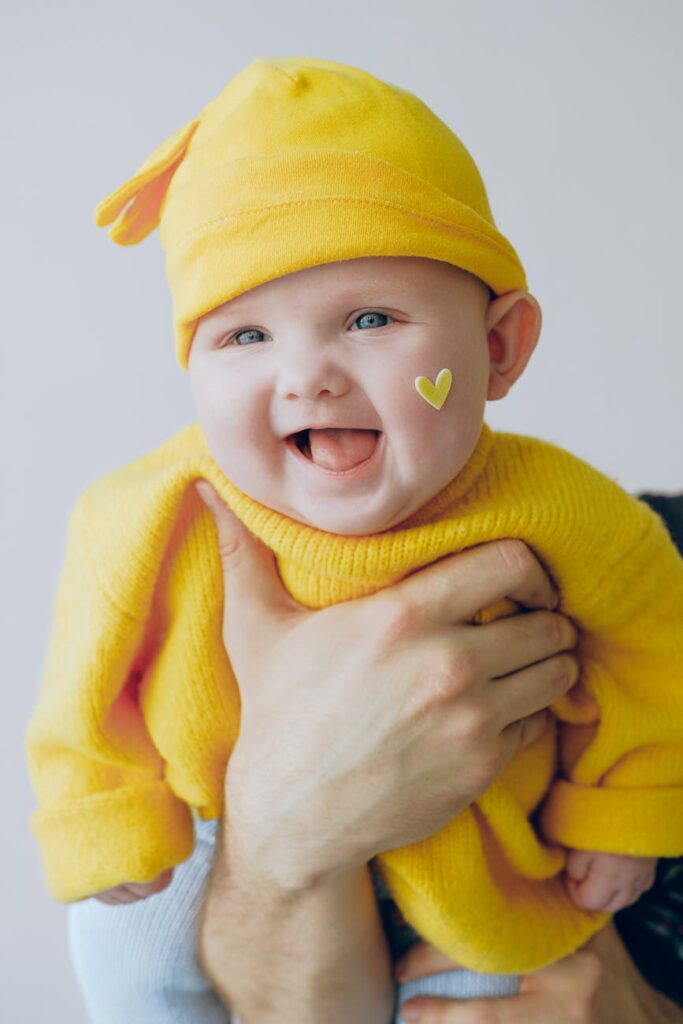 baby in yellow knit cap and yellow knit sweater