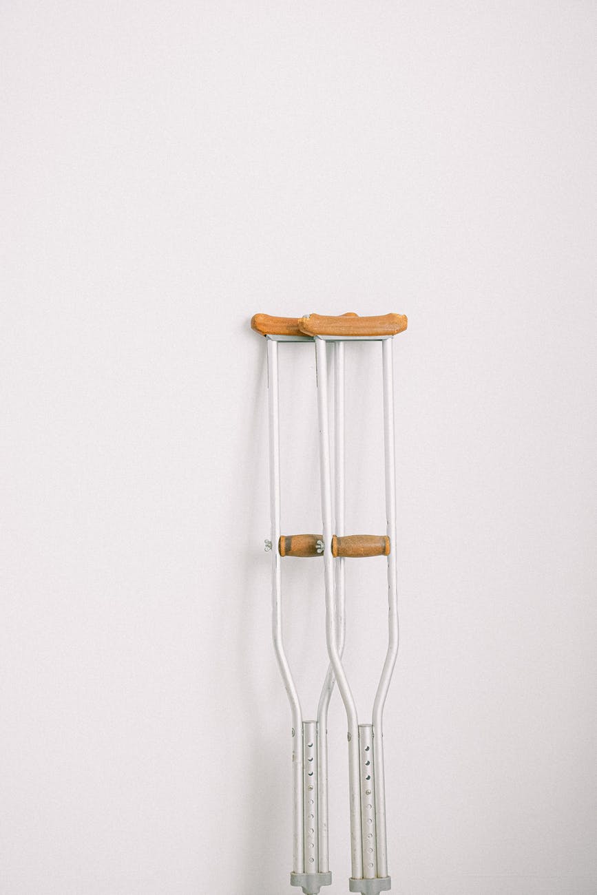 crutches against light white wall
