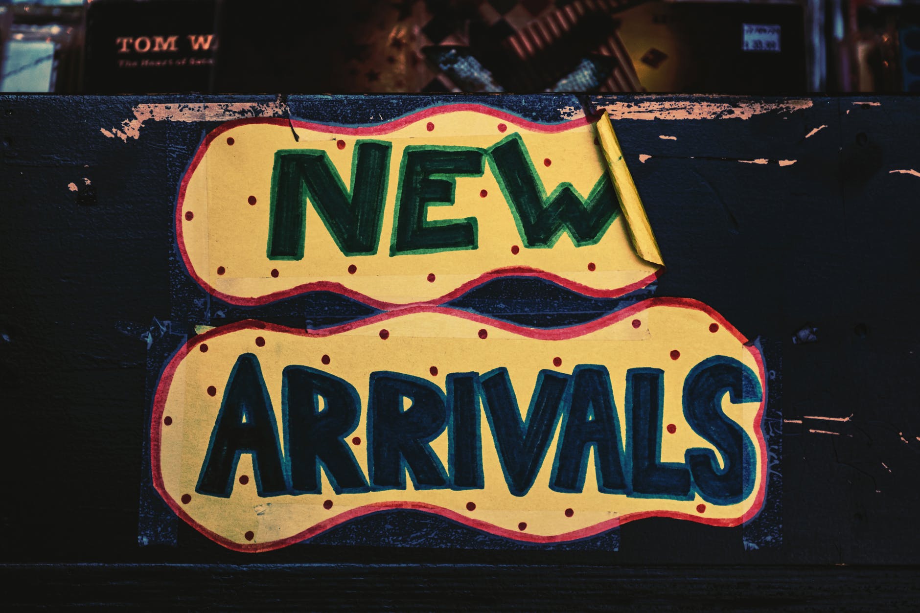 new arrivals sign on wooden surface