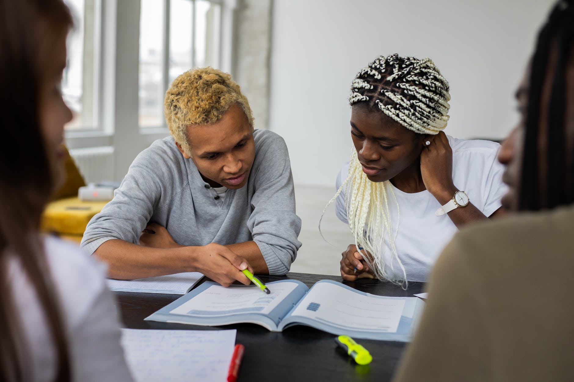 black students reading assignment in textbook