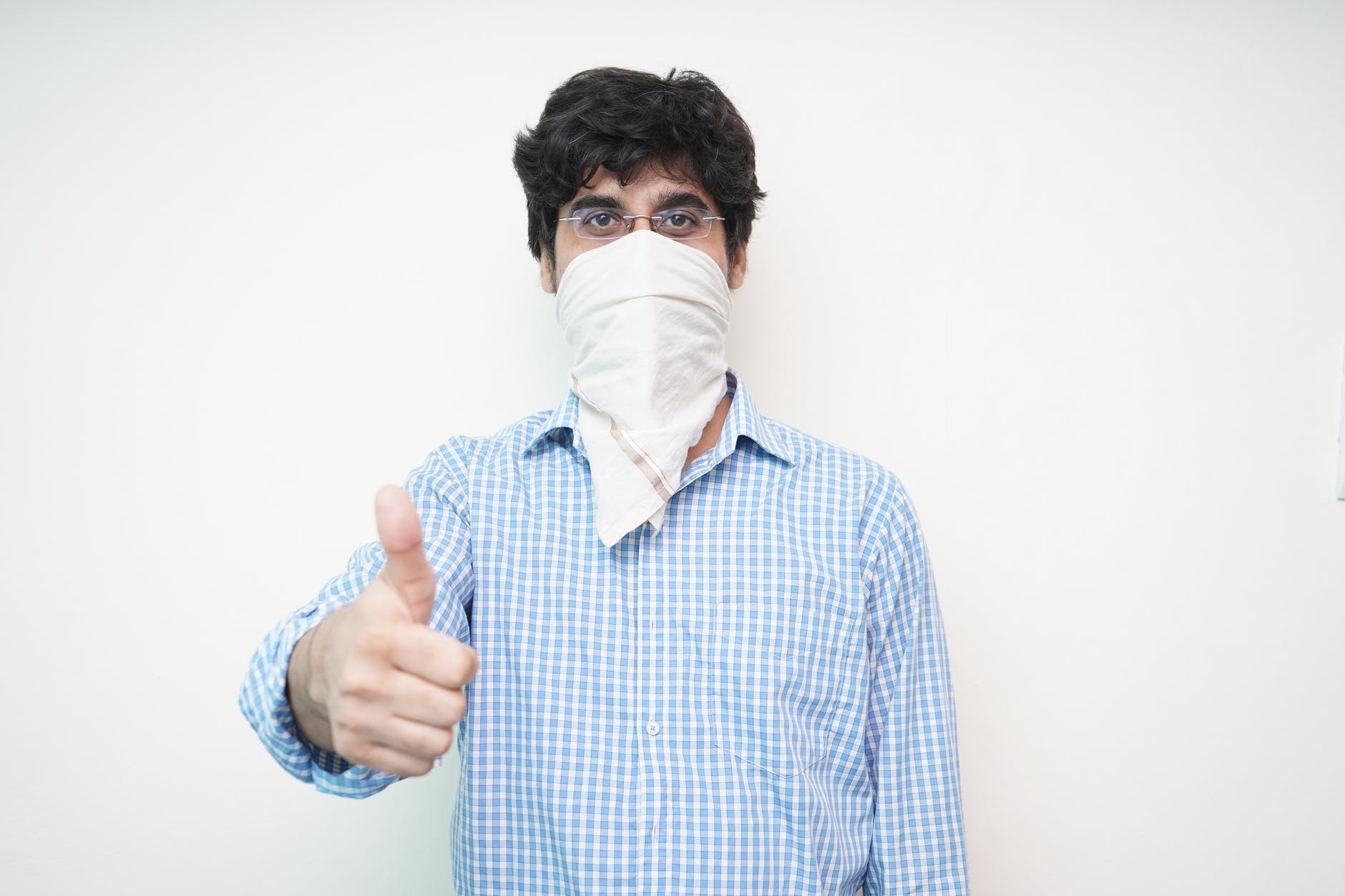 man in blue and white checked button up shirt with white face mask